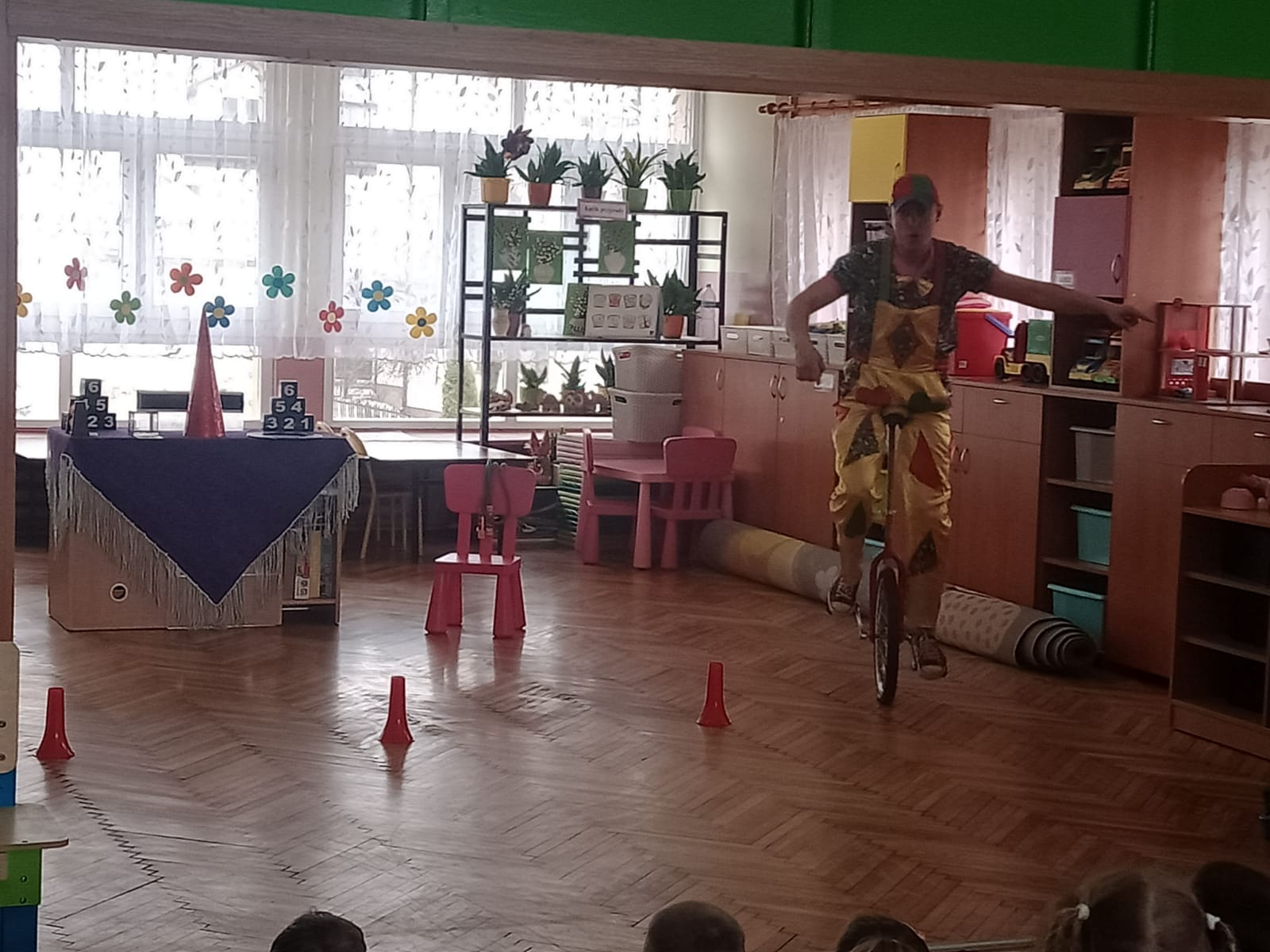 Akrobata cyrkowy jedzie na rowerze jednokołowym